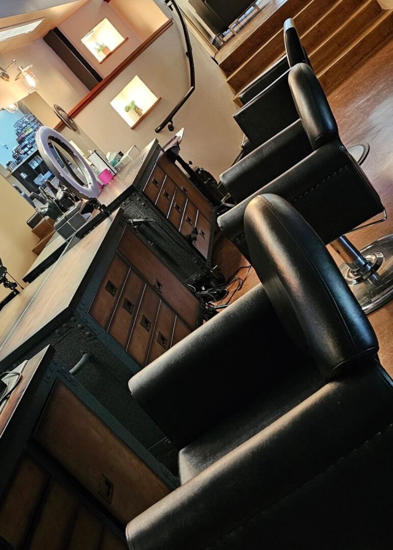 3 hair stations with 3 black chairs