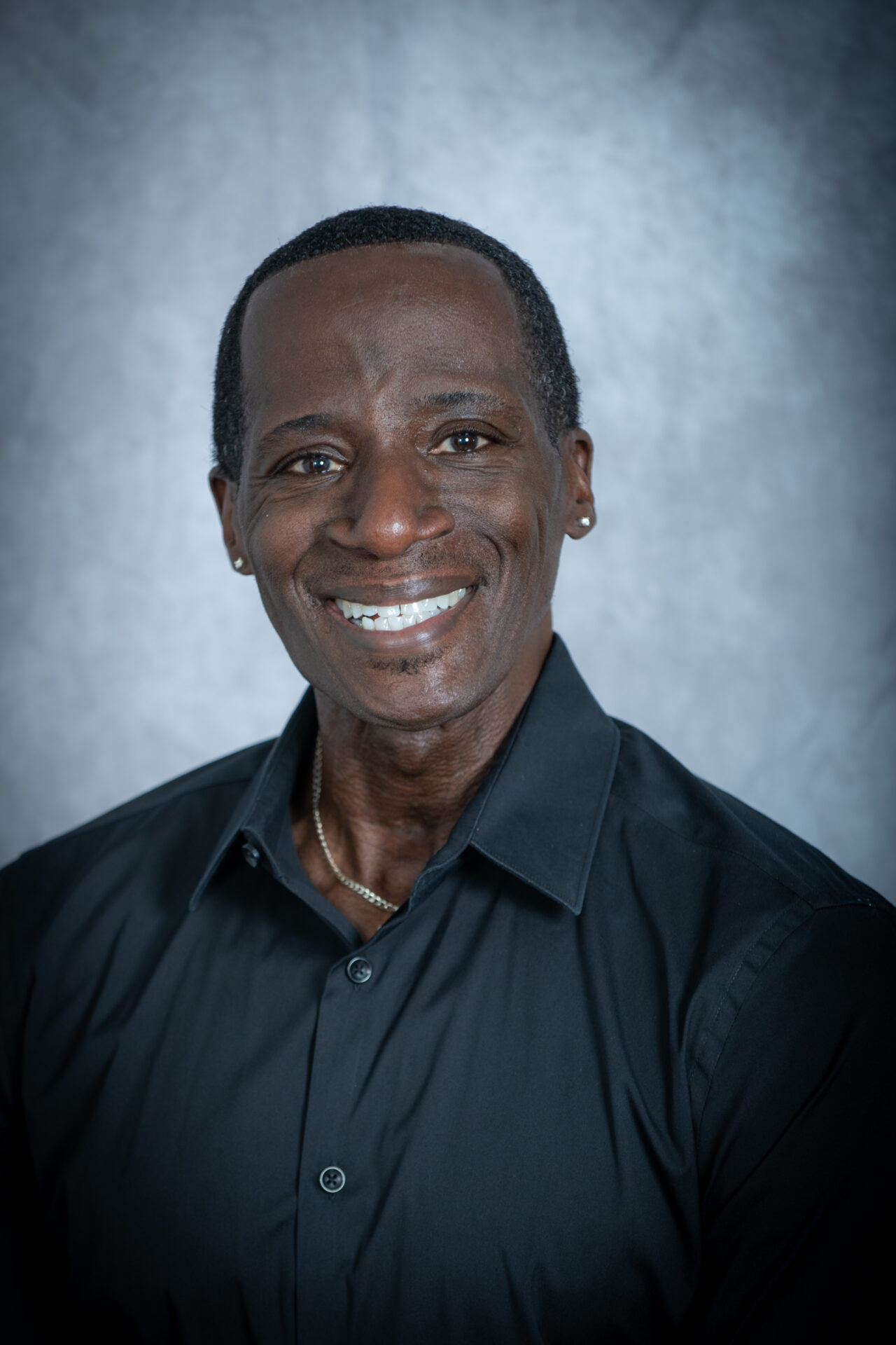 Man smiling with a black shirt