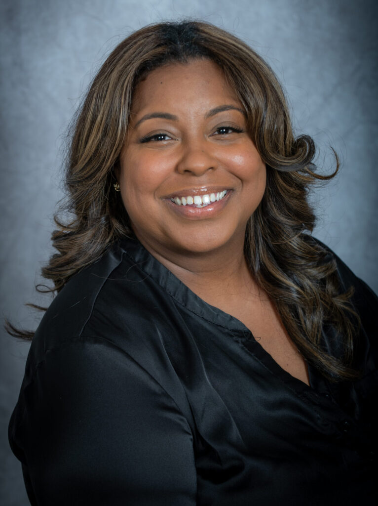 a women of color smiling wereing a black shirt